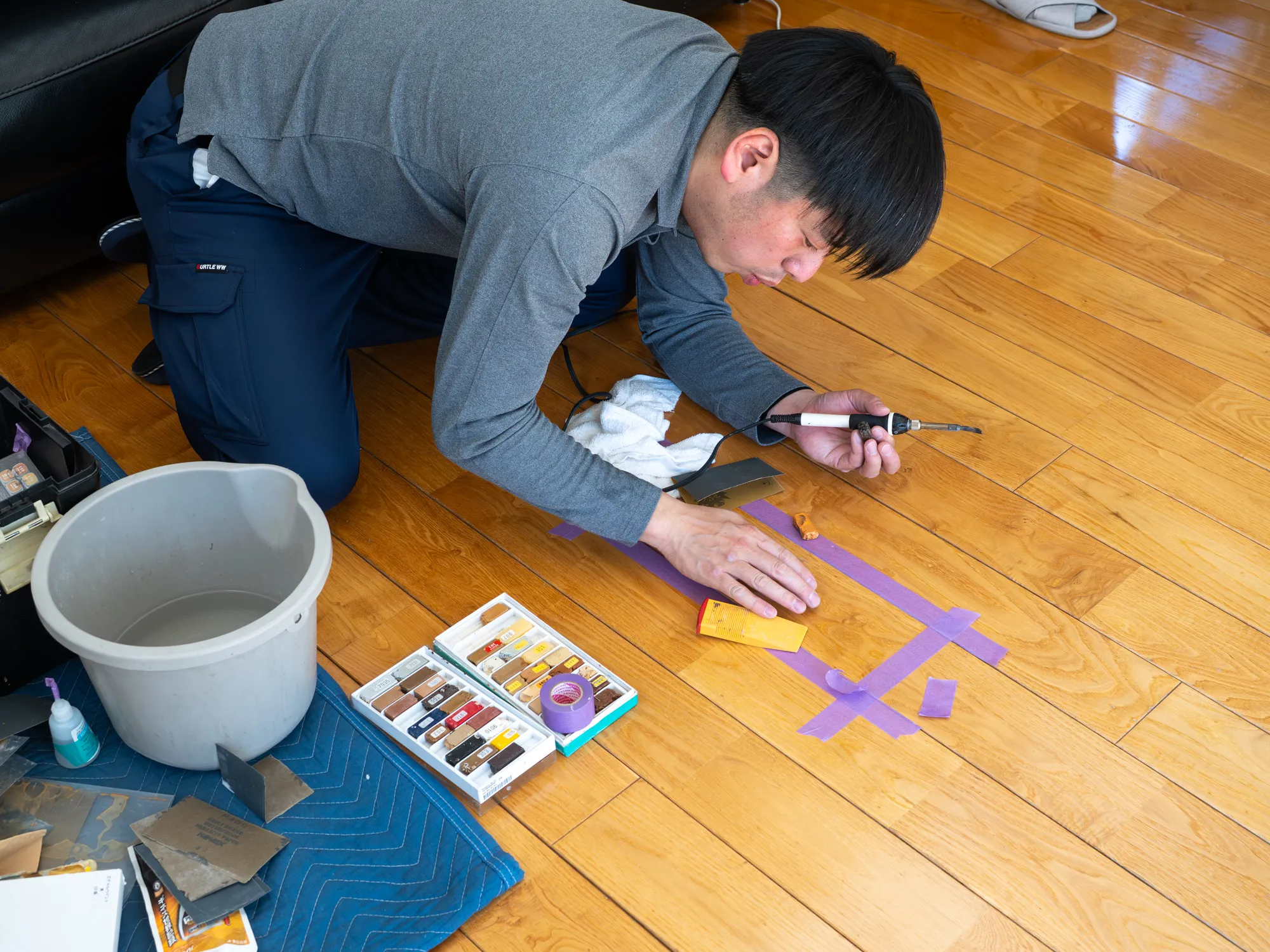 10年点検を機にUVフロアコーティングを再施工すべき箇所を発見。早速、テストでリペア作業をするスタッフ。